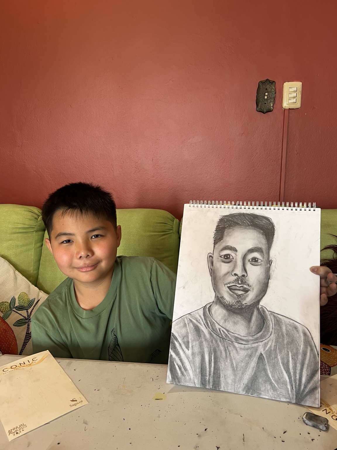 Student with a completed portrait drawing