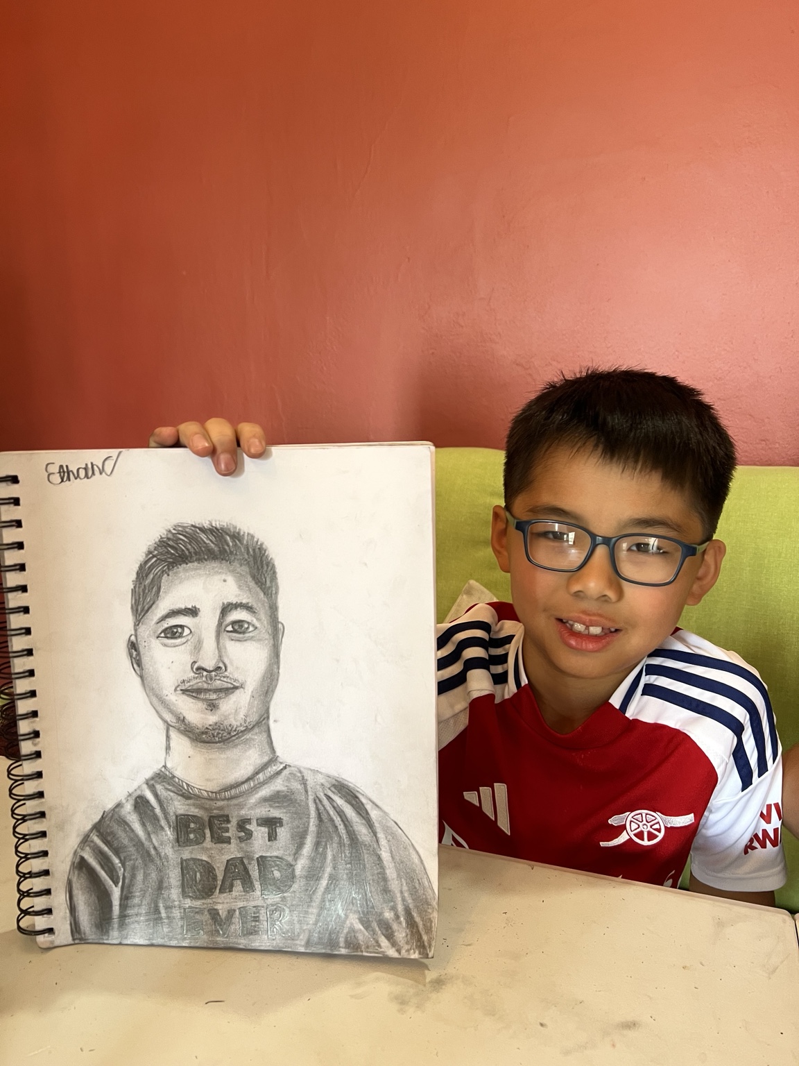 Young artist showing a portrait drawing